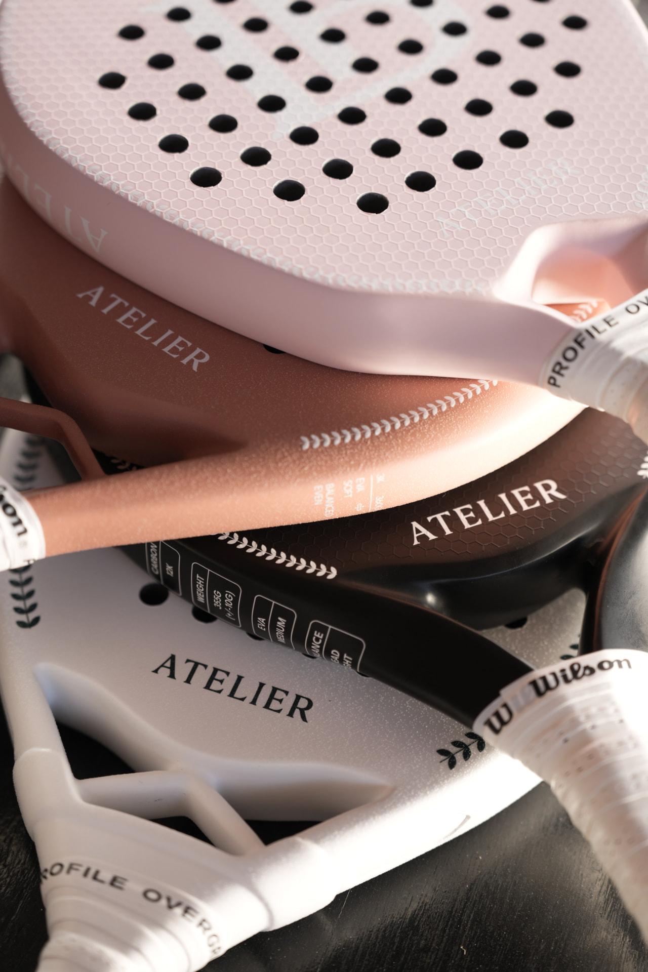 Four LB Atelier padel rackets arranged together