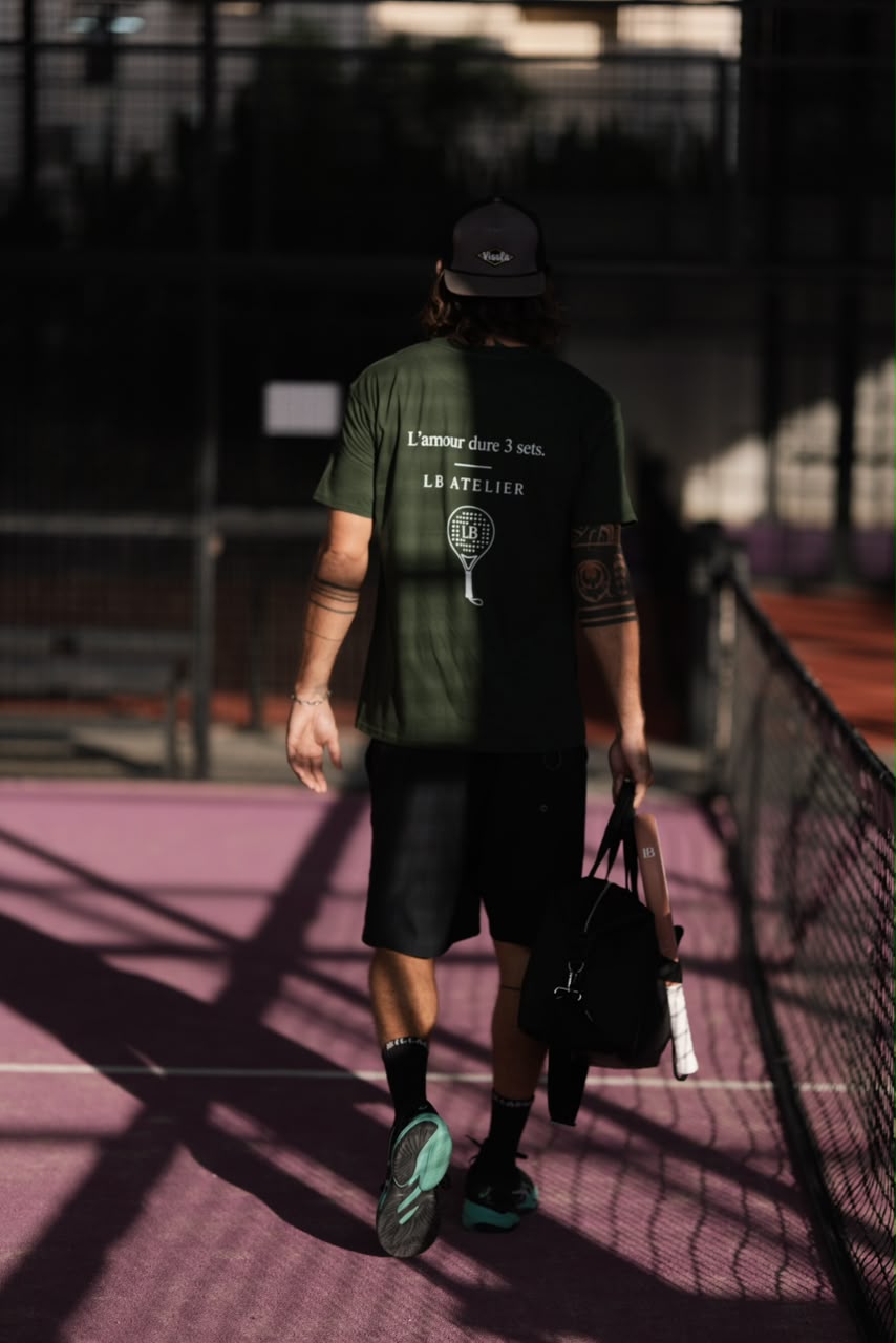 Player walking off a pink padel court with an LB Atelier bag