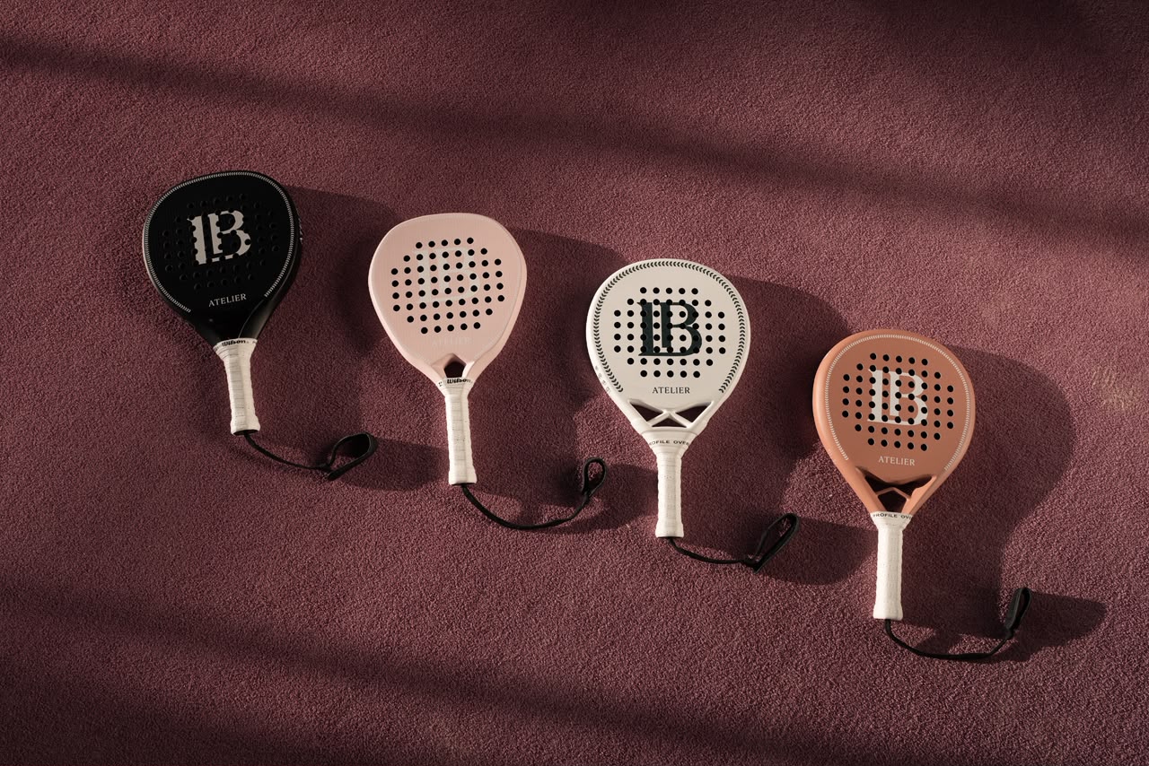 The four LB Atelier rackets arranged on a deep plum court